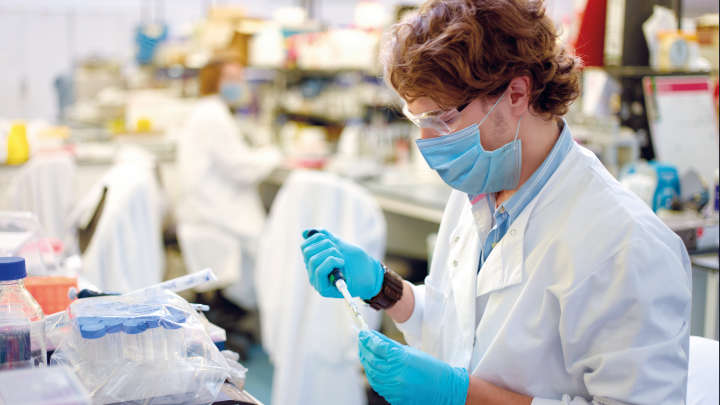 People working in a laboratory, Scientist using micro pipette with DNA
